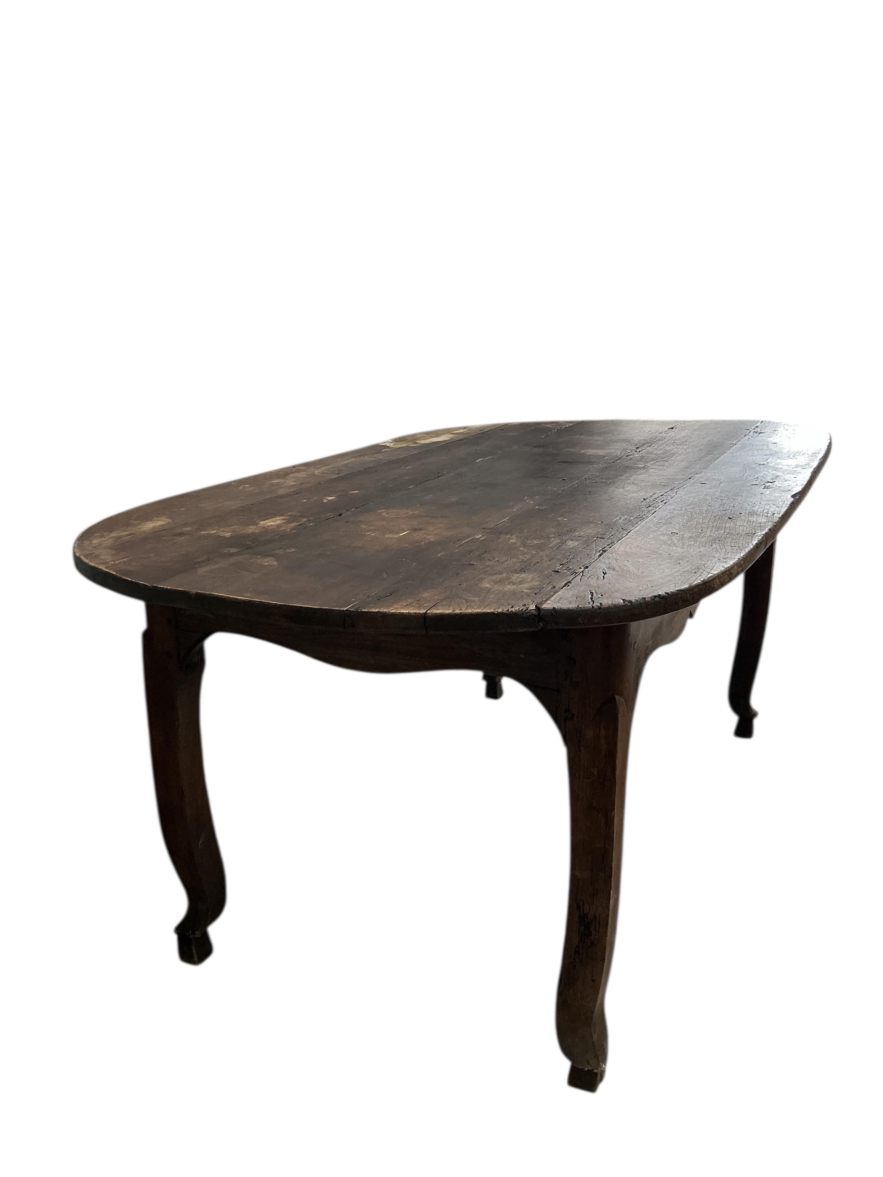 An early 19th century French Provincial oval fruitwood kitchen table, width 180cm, depth 104cm, height 77cm